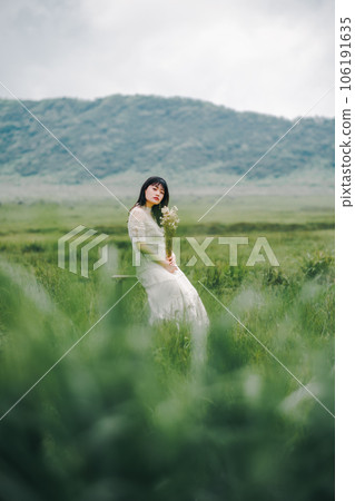 Woman sitting on a chair in the meadow Woman sitting on a chair in the meadow 106191635