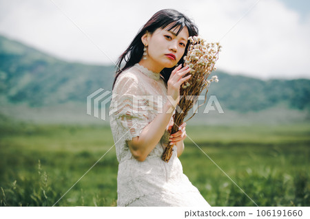 Woman sitting on a chair in the meadow 106191660