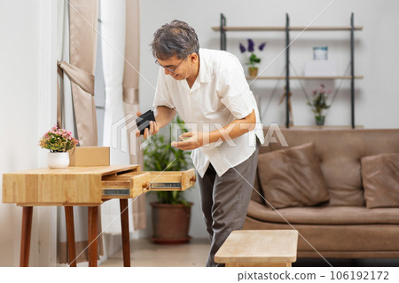 Senior man found his wallet that has forgotten in a drawer 106192172