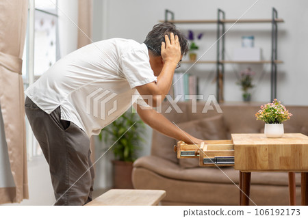 Asian older man finding something that he forgot it in drawers.. 106192173