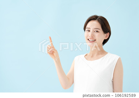 Female pointing blue back 106192589