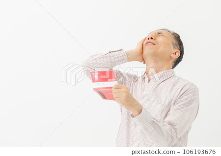 A man who is worried about looking at the passbook A man who is worried about looking at the passbook 106193676