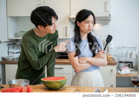 A cute, clingy Asian boyfriend is asking for forgiveness from his unhappy girlfriend after arguing A cute, clingy Asian boyfriend is asking for forgiveness from his unhappy girlfriend after arguing 106194008