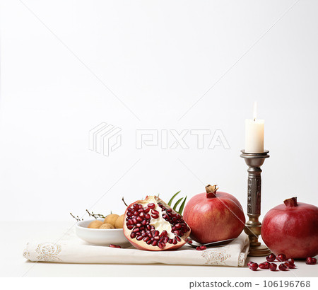 Commemorating Jewish New Year with Fruits, Pomegranates, and Candlelight Commemorating Jewish New Year with Fruits, Pomegranates, and Candlelight 106196768