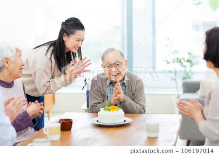 Three generation family grandchild celebrating grandfather 106197014