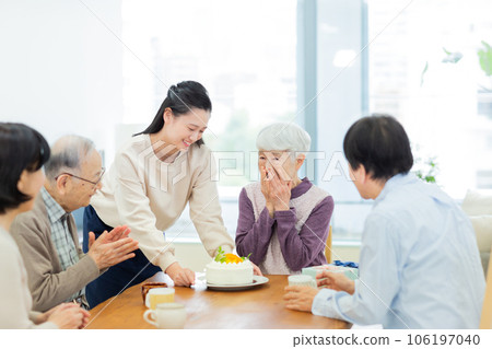 Three generations family grandchild celebrating grandmother Three generations family grandchild celebrating grandmother 106197040