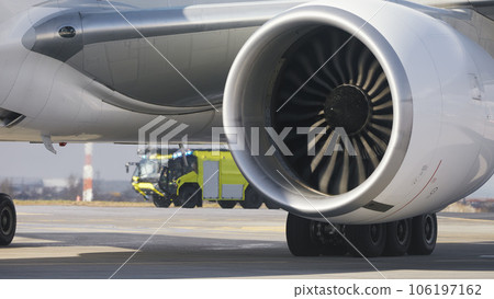 Fire truck of airport rescue and fire brigade behind airplane. 106197162