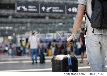 Hand of man holding suitcase at airport. Hand of man holding suitcase at airport. 106197166