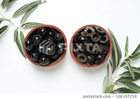 Olives in wooden bowls on white background, top view 106197258