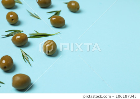Olives and tree leaves on blue background, space for text Olives and tree leaves on blue background, space for text 106197345
