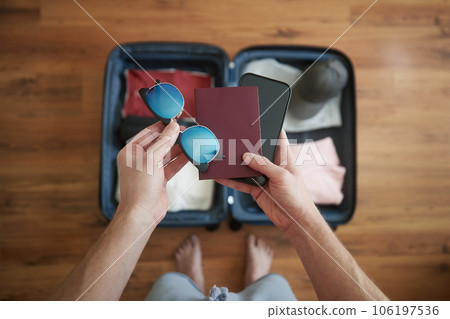 Packing suitcase and planning travel adventure. Packing suitcase and planning travel adventure. 106197536