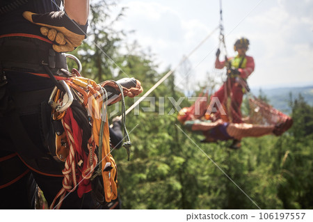 Paramedic with patient in stretcher under helicopter. Paramedic with patient in stretcher under helicopter. 106197557