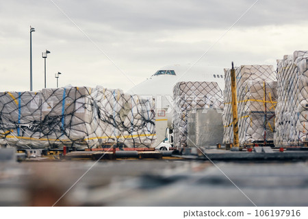 Loading of cargo containers to plane at airport. Loading of cargo containers to plane at airport. 106197916