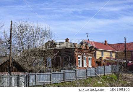 A street with brick houses and a wooden fence in Gorodets, Russia 106199305