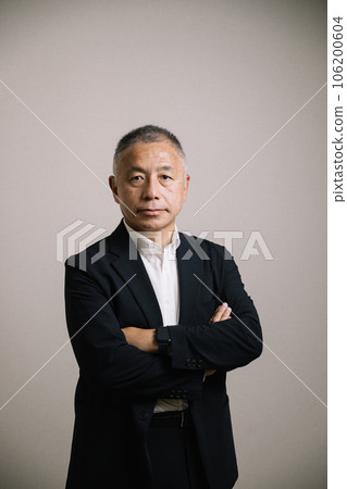 A dignified man in his 50s wearing a jacket 106200604