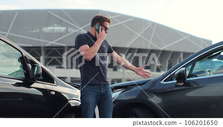 Car accident with wrecked car and man on phone. Man calling to report car accident. Road safety and insurance concept. 106201650