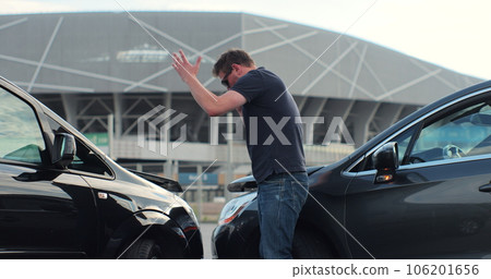 Car accident with wrecked car and man on phone. Man calling to report car accident. Road safety and insurance concept. Car accident with wrecked car and man on phone. Man calling to report car accident. Road safety and insurance concept. 106201656
