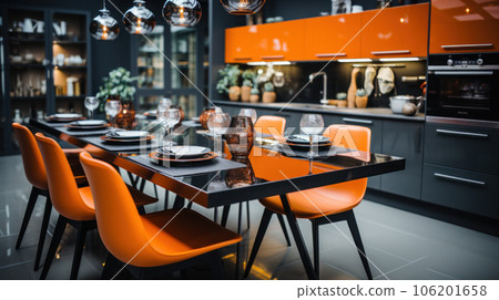 A large table for 8 people with bright orange chairs against the backdrop of a glossy kitchen. 106201658