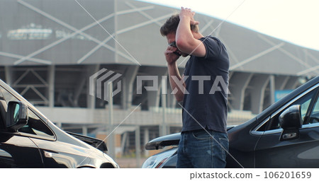 Car accident with wrecked car and man on phone. Man calling to report car accident. Road safety and insurance concept. Car accident with wrecked car and man on phone. Man calling to report car accident. Road safety and insurance concept. 106201659