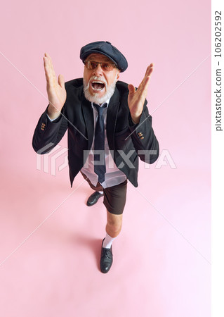 Top view photo of senior bearded man wear shirt black shorts nice sunglass shouting at camera isoalated on pastel pink color background Top view photo of senior bearded man wear shirt black shorts nice sunglass shouting at camera isoalated on pastel pink color background 106202592
