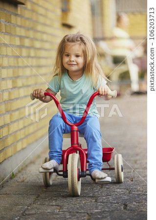 Charming blonde child rides a bicycle in Denmark Charming blonde child rides a bicycle in Denmark 106203713