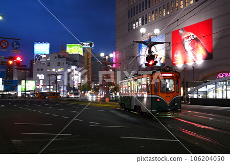 Kagoshima City Tram running in front of Kagoshima Chuo Station Kagoshima City Tram running in front of Kagoshima Chuo Station 106204050