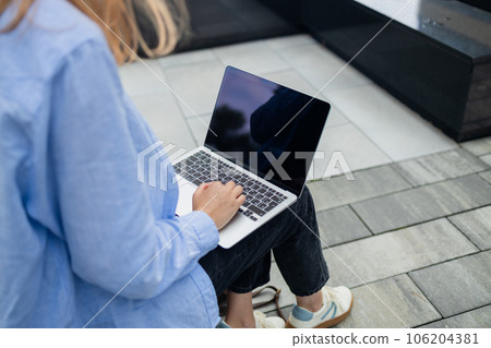 Portrait of successful professional businesswoman in smart casual using laptop outdoors in urban park background. Business people concept. Portrait of successful professional businesswoman in smart casual using laptop outdoors in urban park background. Business people concept. 106204381