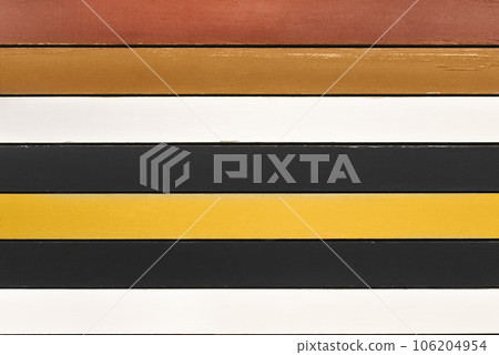 Multicolored wooden planks background. Backdrop made of brown, white, black and yellow planks arranged horizontally. Colorful wood backdrop. 106204954