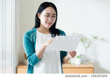 Young woman looking at paperwork 106205930