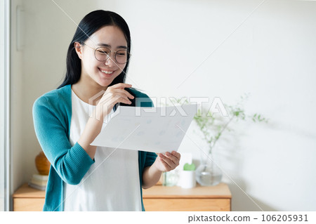 Young woman looking at paperwork 106205931