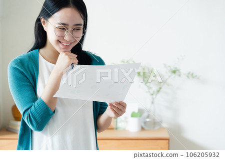 Young woman looking at paperwork Young woman looking at paperwork 106205932