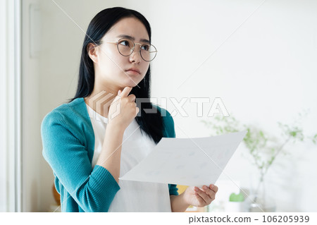 Young woman looking at paperwork 106205939