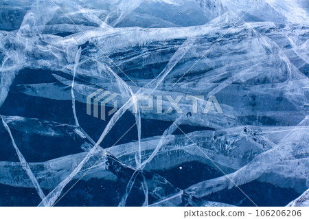 The natural texture of cracked ice of Lake Baikal. Clear blue ice. Layered thick ice. Horizontal. 106206206