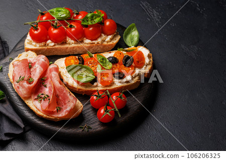 Sandwich set of bruschetta with juicy tomatoes, cheese and prosciutto Sandwich set of bruschetta with juicy tomatoes, cheese and prosciutto 106206325