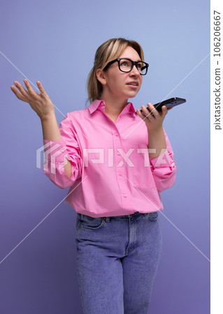 young confident blond woman with ponytail and glasses dressed in a fashionable pink shirt for the 106206667