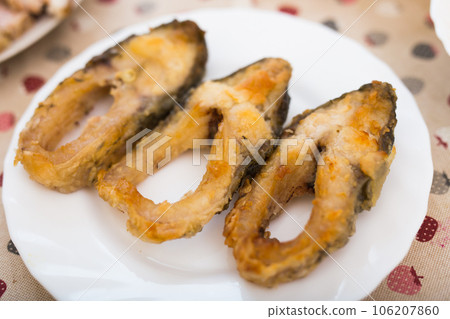 Three pieces of fried carp on a white plate 106207860