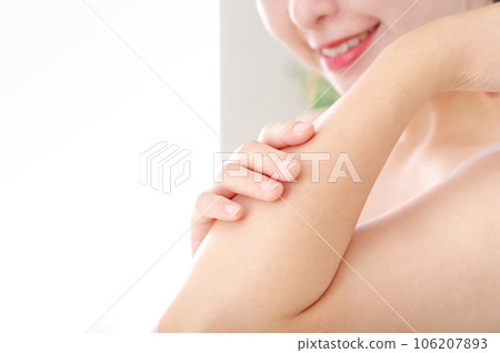 young woman touching her arm 106207893