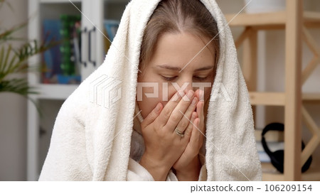 Young woman feeling cold and freezing in her apartment. Concept of energy crisis, high bills, economy and saving money on monthly utility bills. Young woman feeling cold and freezing in her apartment. Concept of energy crisis, high bills, economy and saving money on monthly utility bills. 106209154