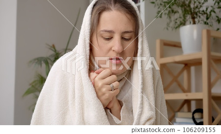 Woman covering in blanket feeling cold in her apartment without heating. Concept of energy crisis, high bills, economy and saving money on monthly utility bills. 106209155