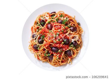 Plate of pasta puttanesca with olives, tomato sauce, anchovies and capers  isolated on white background 106209641