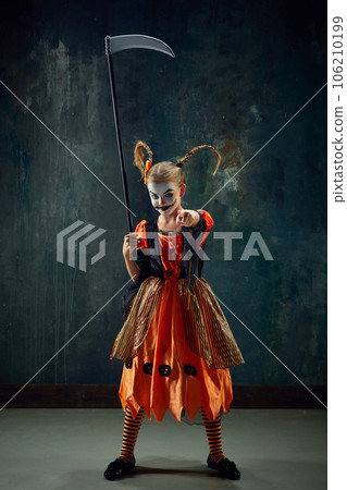 You. Little girl, child with creepy makeup and costume pointing with finger at camera against dark vintage background You. Little girl, child with creepy makeup and costume pointing with finger at camera against dark vintage background 106210199