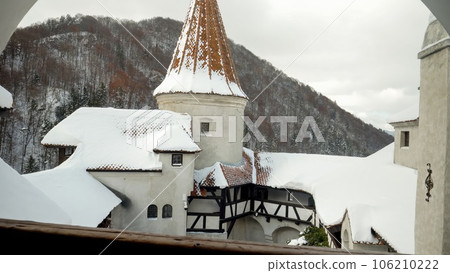 Roof tops and towers covered with snow in medieval castle at winter Roof tops and towers covered with snow in medieval castle at winter 106210222