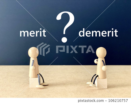 Two dolls _merit and demerit characters sitting on a cube facing each other 106210757