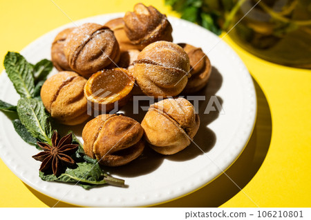 Homemade nut cookies with condensed milk on a yellow background. Homemade nut cookies with condensed milk on a yellow background. 106210801