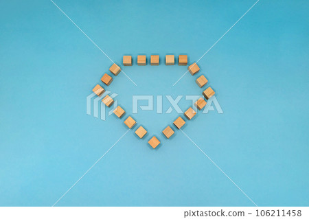 Frame of wood cubes in the shape of diamonds on light blue background Frame of wood cubes in the shape of diamonds on light blue background 106211458