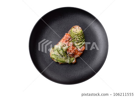 Fresh tasty sandwich with salmon, avocado and sesame and flax seeds Fresh tasty sandwich with salmon, avocado and sesame and flax seeds 106211555