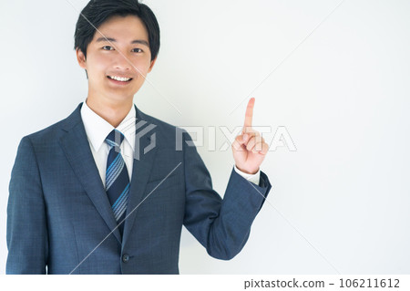 商人一邊看著相機一邊擺出指向的姿勢 商人一邊看著相機一邊擺出指向的姿勢 106211612