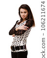 Portrait of a young model in the studio on a white background. A beautiful girl with long hair and red lips in a white dress with polka dots. Fashion and natural beauty concept. 106211674