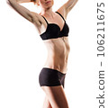 Attractive athletic woman in black bikini posing on white background. Photo of a brunette with a slender body. Beauty and body care concept 106211675