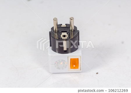 Close up of universal electric socket plug adapters, isolated on white background. Used to connect electrical outlets worldwide. Concept of solution, travel and technology. 106212269